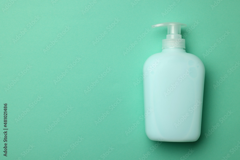 Bottle of liquid soap on turquoise background, top view. Space for text Bottle of liquid soap on turquoise background, top view. Space for text
