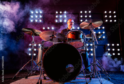 drummer performing in front of audience blinder