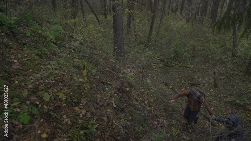 Wallpaper Mural Father lends helping hand to his tired son as they climb uphill during hiking trip at autumn forest Torontodigital.ca