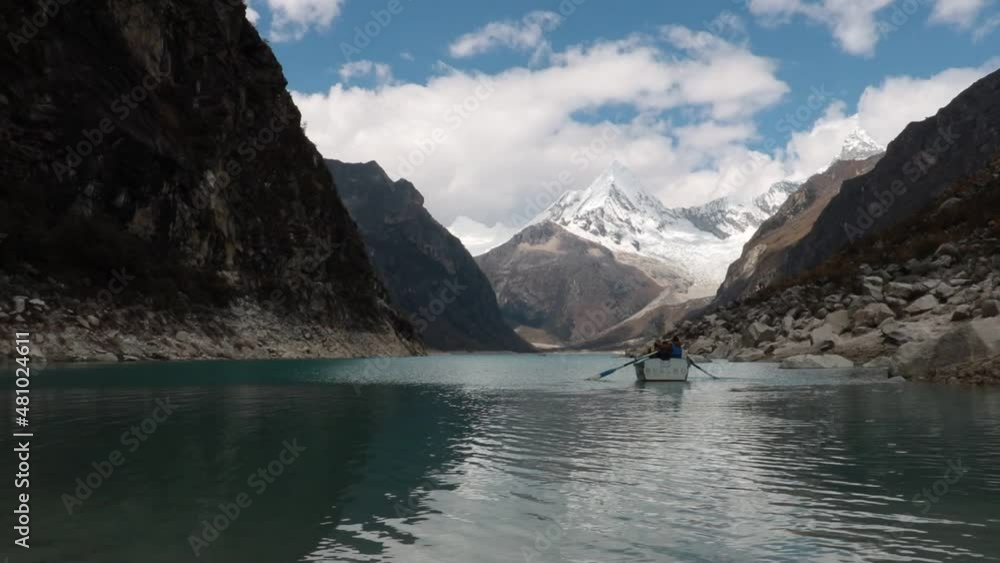 Boat paddles in the mountain lake Paron with its turquoise waters in the high Andes of Peru Boat paddles in the mountain lake Paron with its turquoise waters in the high Andes of Peru