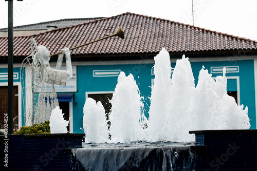 Casa azul de construção clássica e chafariz na frente. Cidade de Guararema interior de São Paulo, Brasil.  photo