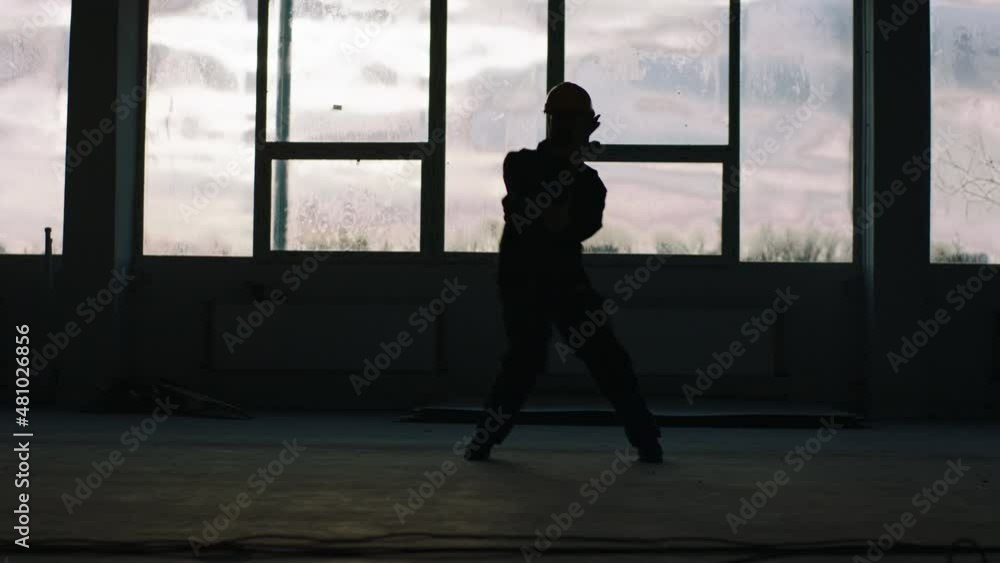 Modern construction building with panoramic view construction guy dancing excited in front of the camera at the end of the day Modern construction building with panoramic view construction guy dancing excited in front of the camera at the end of the day