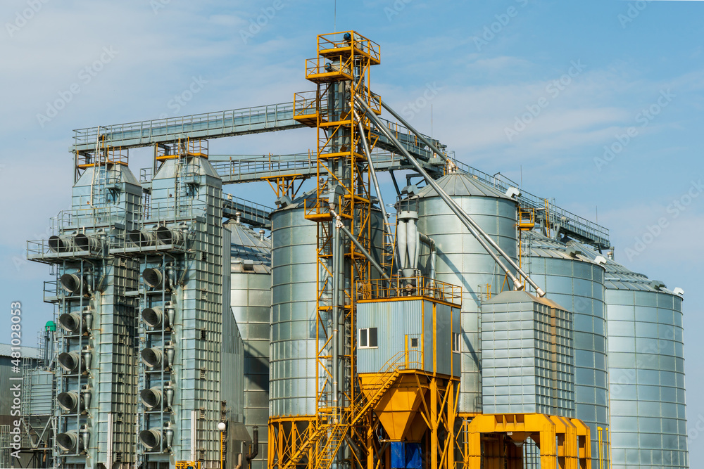 A large modern plant for the storage and processing of grain crops. view of the granary on a sunny day against the blue sky. End of harvest season.