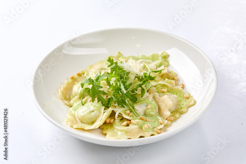 ravioli with pesto sauce on white plate