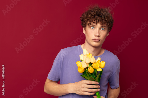 kinky guy red hair in casual wear bouquet of flowers gift red background unaltered
