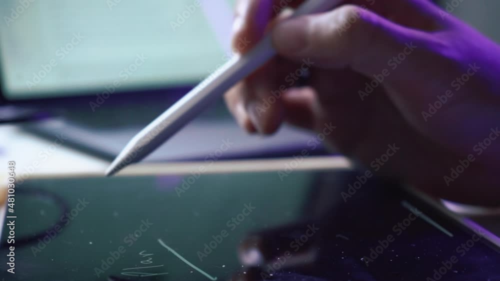 Hand using iPad tablet with wireless Apple pencil pen to wrote a text. High quality FullHD footage