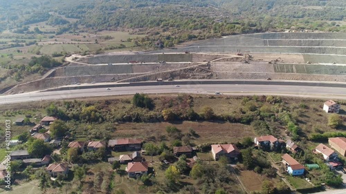 Road and sidehill cut. Construction in progress. Drone shot. Road and landslide protected cut hill. Construction in progress. Aerial drone shot. Massive hill cut to make way for a road. Sidehill cut. photo