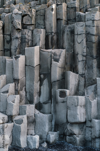 Obraz na płótnie Basalt rock pillars columns at Reynisfjara beach near Vik, South Iceland. Unique geological volcanic formations. Natural stone texture background. w salonie