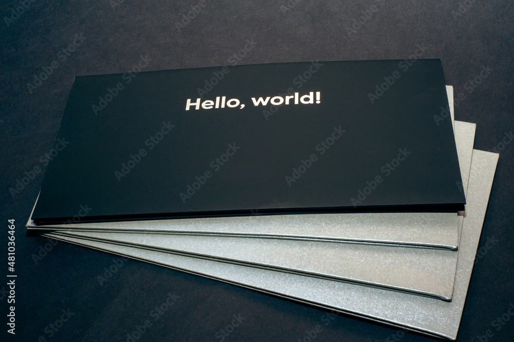 Black envelope on top, on gray envelopes on the bottom, on a dark flat background, luxury corporate identity and corporate identity design for layouts with the inscription hello world Black envelope on top, on gray envelopes on the bottom, on a dark flat background, luxury corporate identity and corporate identity design for layouts with the inscription hello world