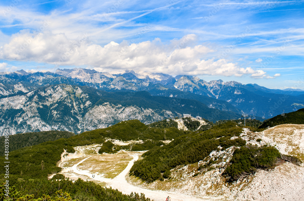 Rocky mountain peaks in the Julian Alps in Slovenia near the Vogel hill. Summer mountains and landscape over Lake Bohinj.