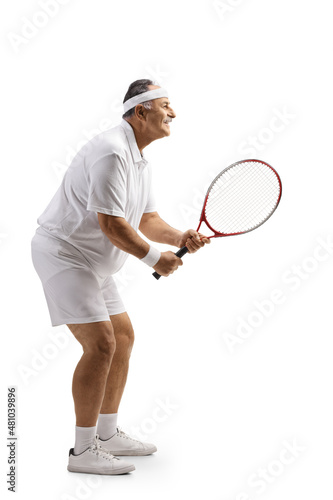 Full length profile shot of a mature man playing tennis © Ljupco Smokovski