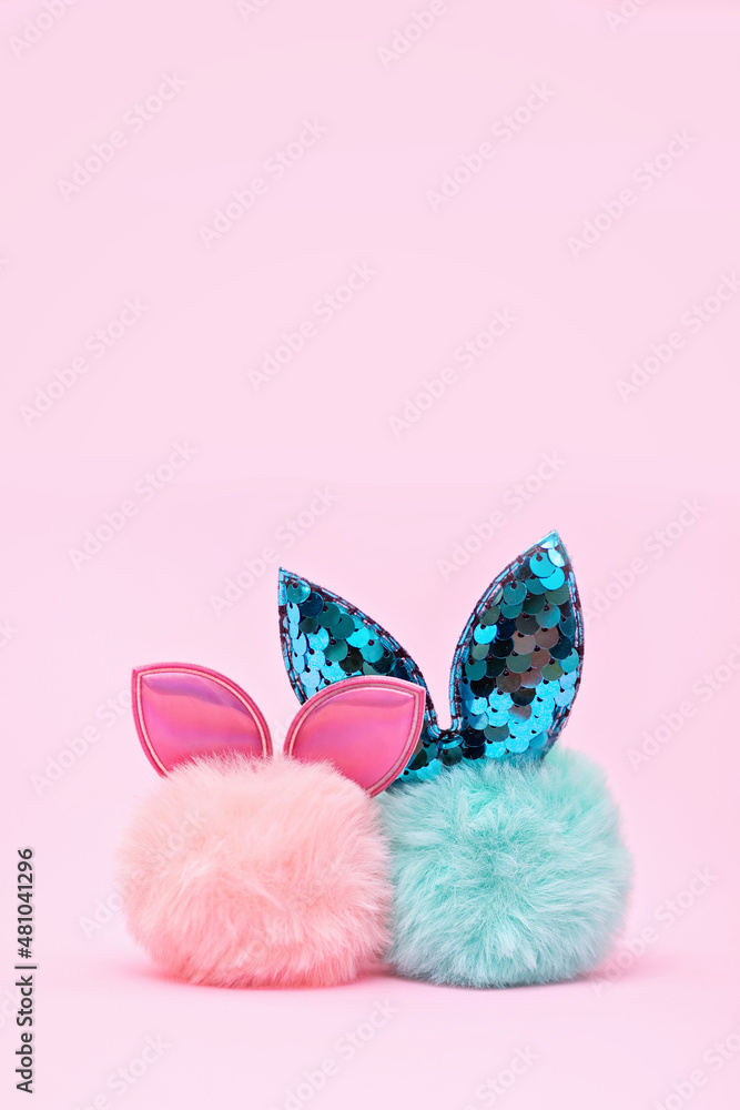 Easter blue and pink fur bunny on pink background. Minimal Easter concept
