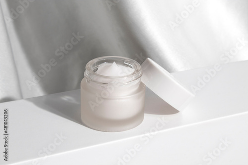 daycream lotion skincare with bottle jar container on sunlight, whitening cream branding mockup photo