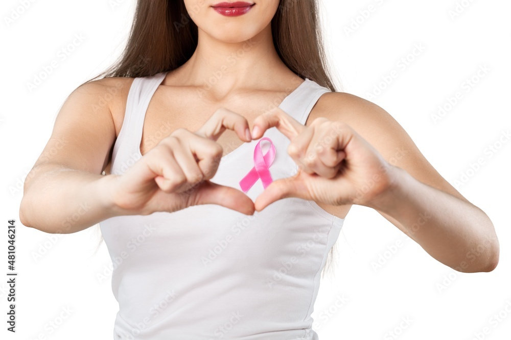 Heart framing on woman chest with pink badge Heart framing on woman chest with pink badge