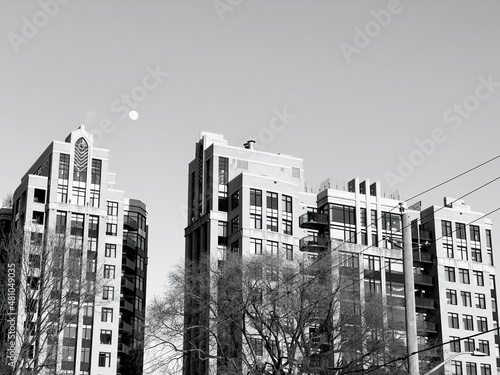 The moon in the sky over condo buildings