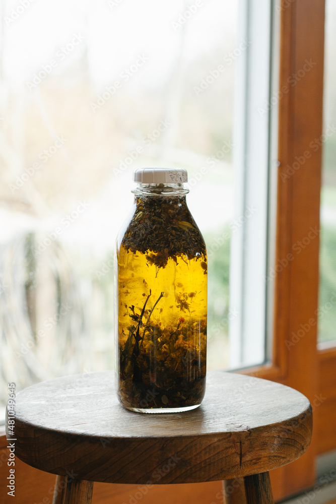 A Jar of Oil Infused with Plants and Herbs A Jar of Oil Infused with Plants and Herbs
