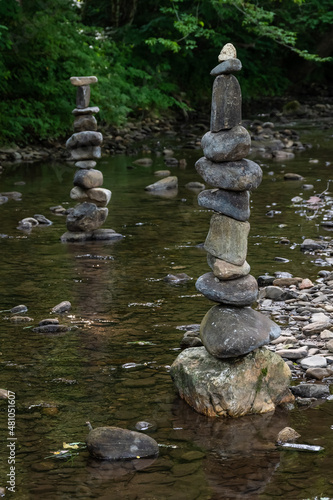 Rough Stone Cairns Standing Proudly in the Shallow Creek Water