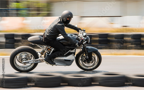 man rides his electric motorcycle on race track in Bangkok photo