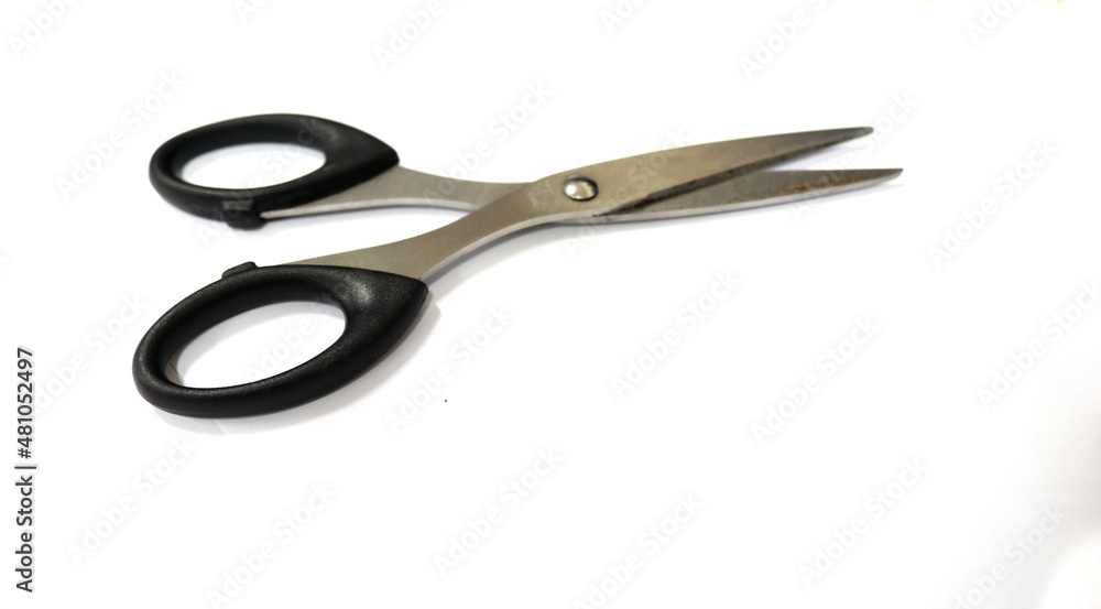 Photo Scissors of black paper, this tool is for cutting. This photo is with a white background Photo Scissors of black paper, this tool is for cutting. This photo is with a white background