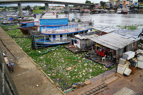 Wallpaper Mural Plastic waste pollution. The Rio Negro river near the metropolis of Manaus. Garbage in the river banks between boats, ships and houseboats. Manaus, Amazon region, Brasil Torontodigital.ca