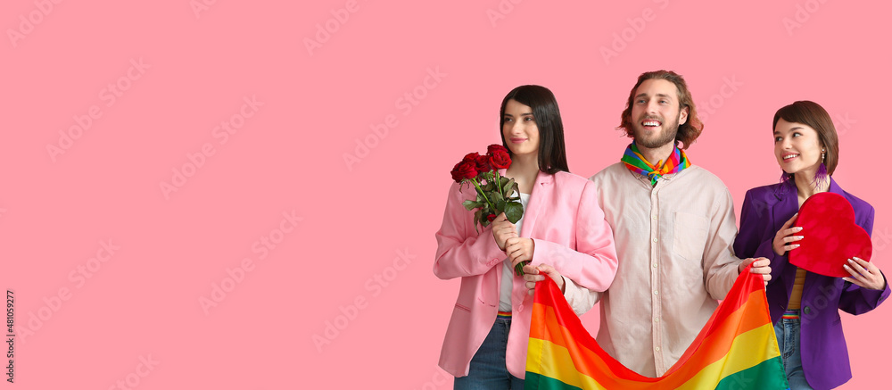 Man and two beautiful women with rainbow flag, gift and flowers on color background with space for text. Concept of polyamory and LGBT