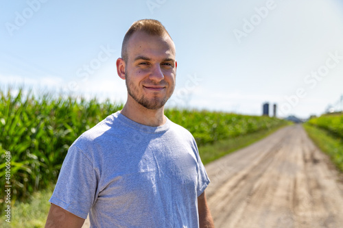 Proud farmer looking at the camera in a corn field. High quality photo