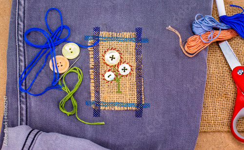 Bilde på lerret Visible mending on jeans, creative sustainable fashion, repair, mend and recycle