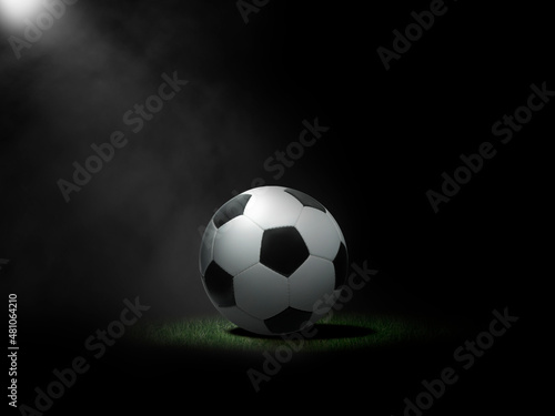 Soccer ball on lawn with black background
