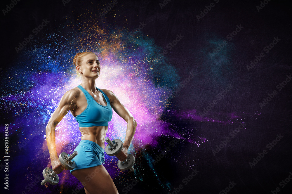 Obraz premium Young beautiful girl doing exercise against dark background