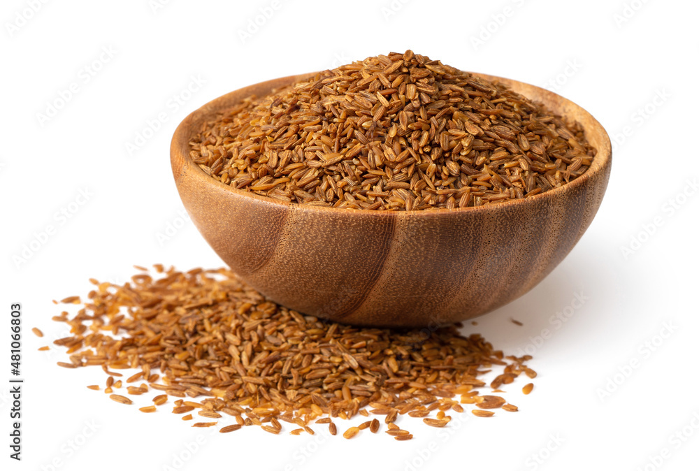 Roasted cumin seeds in the wooden spoon, isolated on the white background. Roasted cumin seeds in the wooden spoon, isolated on the white background.