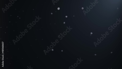 Dust snow particles falling down with light wind blowing from the west on black background. Seamless loop for live wallpaper, game design and chromakey in video editing. Bluish grey themed and calm. 