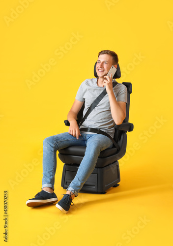 Man in car seat talking by ...
