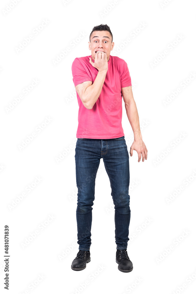 Anxious man biting nails in white studio Anxious man biting nails in white studio