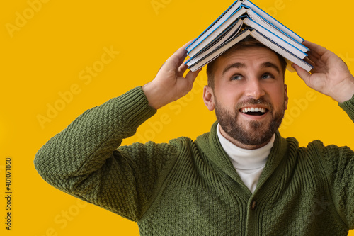 Happy young man with books ...