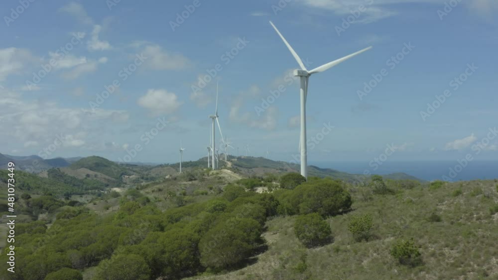 Windmill turbines spinning at Monte Cristi, Dominican Republic. Aerial flying forward Windmill turbines spinning at Monte Cristi, Dominican Republic. Aerial flying forward