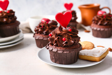 Tasty chocolate cupcakes for Valentine's day on light background, closeup