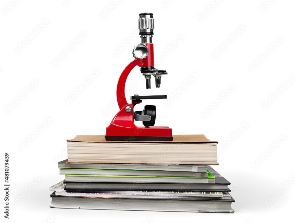 The scientific microscope on a stack of study books The scientific microscope on a stack of study books