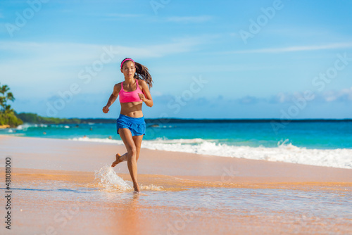 Running athlete woman exercising on beach run jogging living healthy active lifestyle. Fit and active Asian girl training
