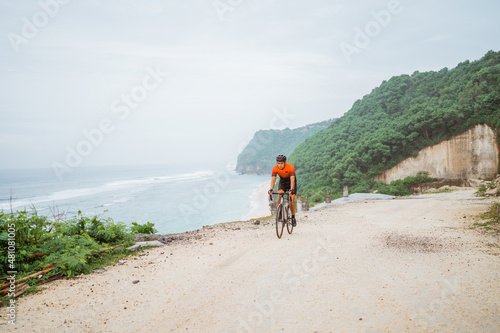 road bike cyclist riding his bike on a cliff