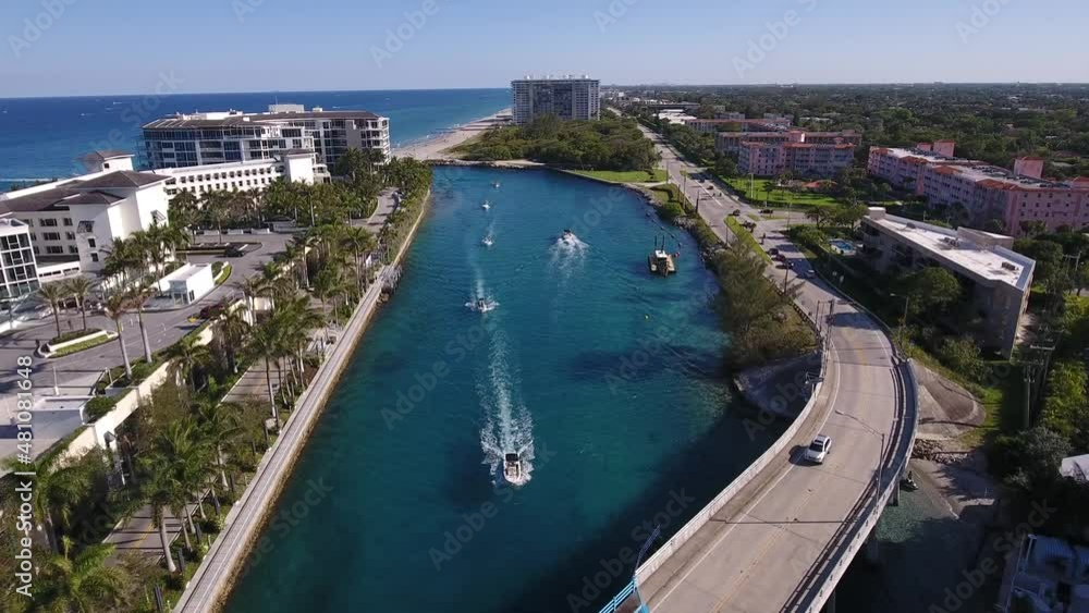Drone flying over bridge over a canal in Boca Raton Florida to a tilt down shot over a boat. Drone flying over bridge over a canal in Boca Raton Florida to a tilt down shot over a boat.