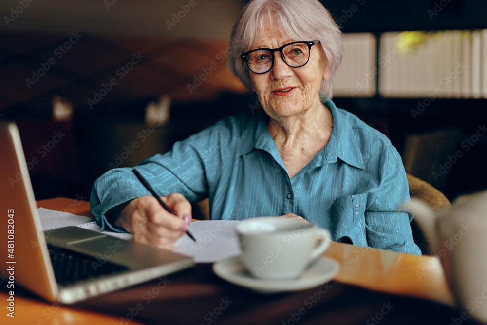 elderly woman documents work sheet of paper and pen Retired woman chatting unaltered elderly woman documents work sheet of paper and pen Retired woman chatting unaltered