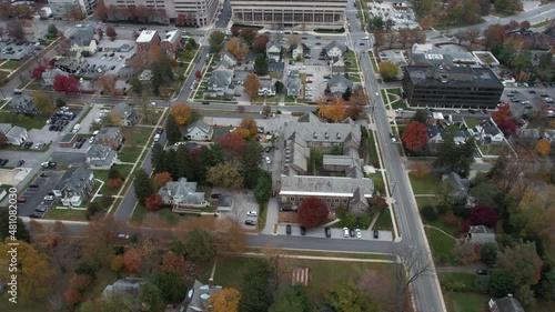 Towson, Maryland USA. Aerial View of Residential Neighborhood and Downtown Buildings in Autumn Season, Revealing Tilt Up Drone Shot photo