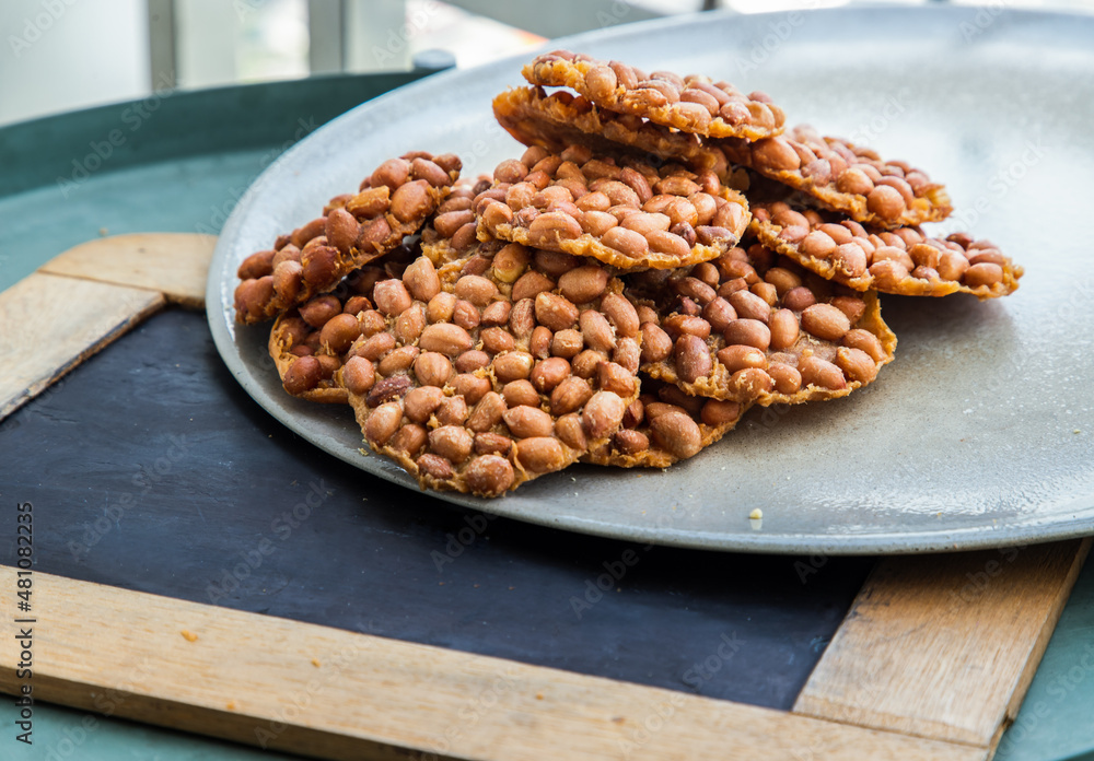 Traditional Thai Snack : Peanut crackers made from nuts and flour to fry on plate. Deep Fried Bean cookies peanut, Selective focus.