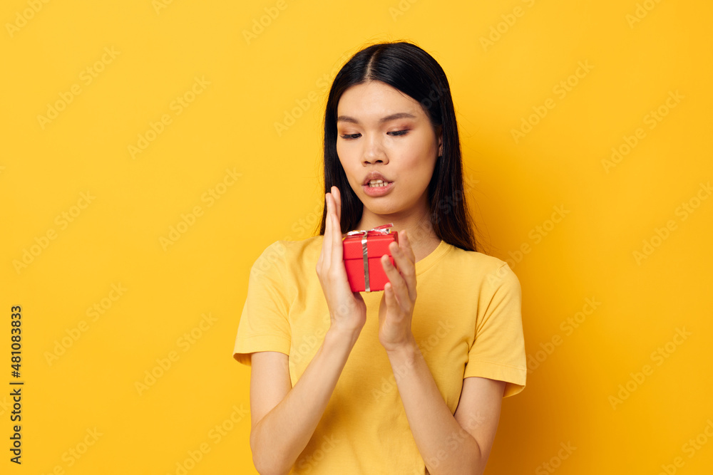 woman holding a gift box in his hands posing isolated background unaltered woman holding a gift box in his hands posing isolated background unaltered