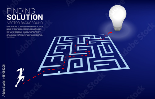 Silhouette of businesswoman running with route path to exit the maze to light bulb. Business concept for problem solving and finding idea.