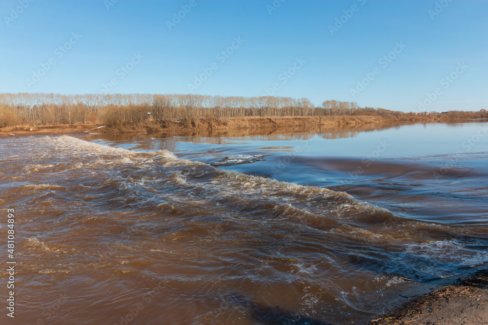 spilled river banks in autumn with blue sky