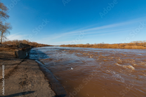 spilled river banks in autumn with blue sky