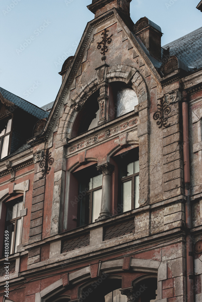 Old Art Nouveau building with wall decor. Red house wall on a sunny day. Riga, Latvia, January 2022 Old Art Nouveau building with wall decor. Red house wall on a sunny day. Riga, Latvia, January 2022