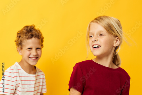 picture of positive boy and girl cuddling fashion childhood entertainment isolated background