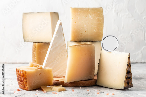Cheese board of various types of soft and hard cheese. spanish manchego cheese, International dairy delicacies. vertical image